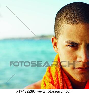 Stock Photo - front view portrait 
of young man holding 
towel over shoulder. 
fotosearch - search 
stock photos, 
pictures, images, 
and photo clipart