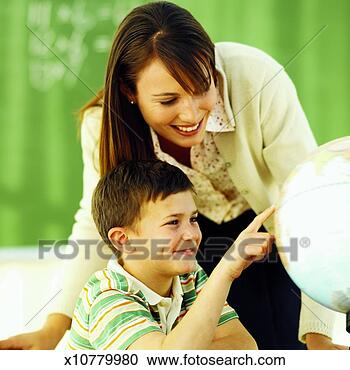 Stock Photography - close-up of teacher 
and student looking 
at globe (10-11). 
fotosearch - search 
stock photos, 
pictures, images, 
and photo clipart