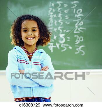 Stock Photograph - front view portrait 
of girl standing 
in front of chalkboard 
with arms. fotosearch 
- search stock 
photos, pictures, 
images, and photo 
clipart