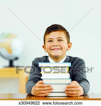 Stock Photo - front view portrait 
of boy holding 
stack of books 
(10-11). fotosearch 
- search stock 
photos, pictures, 
images, and photo 
clipart