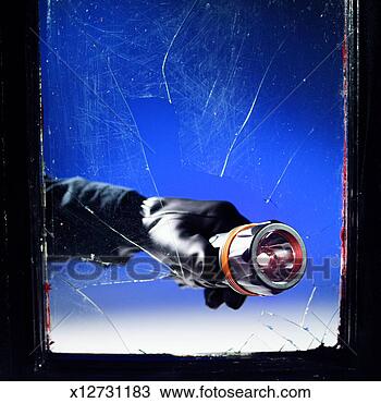 Stock Photo - close-up of man's 
hand breaking 
glass with torch. 
fotosearch - search 
stock photos, 
pictures, images, 
and photo clipart