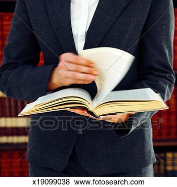 Stock Photo - front view mid 
section of female 
lawyer holding 
law book. fotosearch 
- search stock 
photos, pictures, 
images, and photo 
clipart