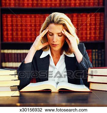 Stock Photo of Front view of female lawyer reading book ...