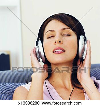 Stock Photography - close-up of young 
woman listening 
to music with 
headphones. fotosearch 
- search stock 
photos, pictures, 
images, and photo 
clipart