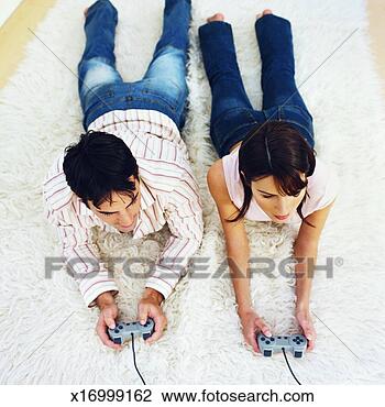 Stock Photo - elevated view 
of young couple 
playing computer 
game. fotosearch 
- search stock 
photos, pictures, 
images, and photo 
clipart