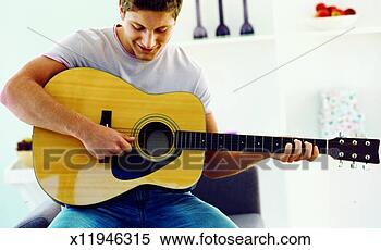Stock Image - front view of 
young man playing 
guitar. fotosearch 
- search stock 
photos, pictures, 
images, and photo 
clipart