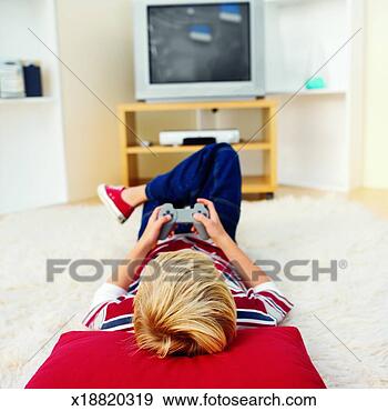 Stock Photograph - rear view of boy 
playing computer 
game (10-11). 
fotosearch - search 
stock photos, 
pictures, images, 
and photo clipart