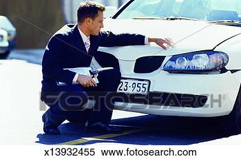 Stock Image - close-up of accessor 
examining car 
damage for insurance. 
fotosearch - search 
stock photos, 
pictures, images, 
and photo clipart