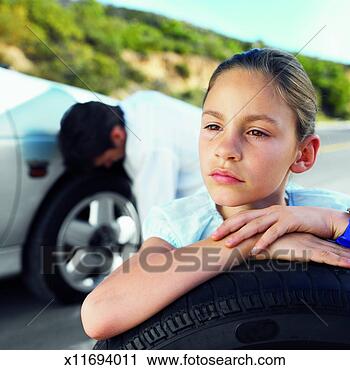 Stock Photography - close-up father 
changing flat 
tire of car and 
daughter holding 
spare. fotosearch 
- search stock 
photos, pictures, 
images, and photo 
clipart
