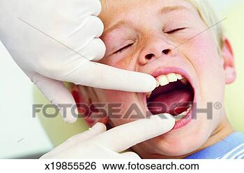 Stock Photo - close-up of dentist 
examining boy's 
teeth (10-11). 
fotosearch - search 
stock photos, 
pictures, images, 
and photo clipart