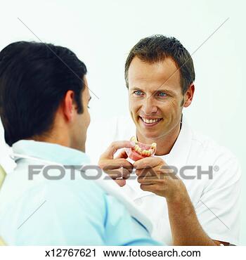 Stock Photography - close-up of dentist 
showing patient 
problem with teeth. 
fotosearch - search 
stock photos, 
pictures, images, 
and photo clipart