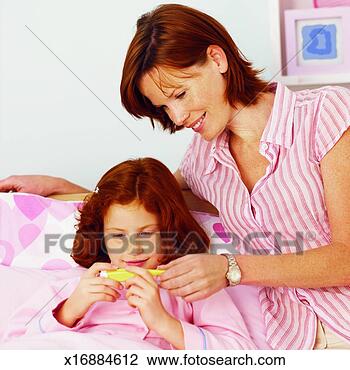 Stock Photo - close-up of mother 
checking temperature 
of daughter with 
thermometer. fotosearch 
- search stock 
photos, pictures, 
images, and photo 
clipart