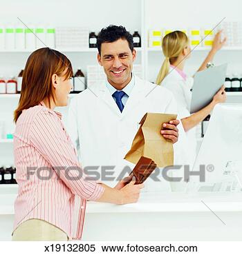Stock Image - close-up of pharmacist 
giving container 
of tablets to 
patient. fotosearch 
- search stock 
photos, pictures, 
images, and photo 
clipart