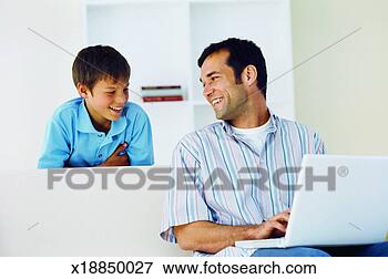 Picture - close-up of father 
working on laptop 
and son watching 
him (11-12). fotosearch 
- search stock 
photos, pictures, 
images, and photo 
clipart