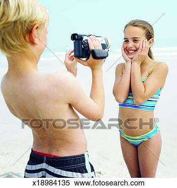 Stock Image - boy (10-11) filming 
his sister (11-12). 
fotosearch - search 
stock photos, 
pictures, images, 
and photo clipart