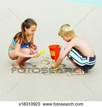 Stock Photo - brother (6-7) 
and sister (8-9) 
playing at the 
beach. fotosearch 
- search stock 
photos, pictures, 
images, and photo 
clipart