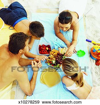 Stock Photograph - elevated view 
of a family having 
a picnic at the 
beach. fotosearch 
- search stock 
photos, pictures, 
images, and photo 
clipart