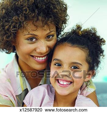 Stock Photography - front view portrait 
of mother and 
daughter smiling 
(8-9). fotosearch 
- search stock 
photos, pictures, 
images, and photo 
clipart