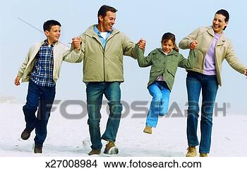 Stock Photo - playful family 
walking together 
on a beach. fotosearch 
- search stock 
photos, pictures, 
images, and photo 
clipart