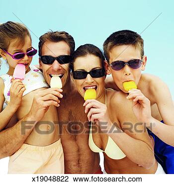 Stock Photo - portrait of a 
family at the 
beach eating popsicles. 
fotosearch - search 
stock photos, 
pictures, images, 
and photo clipart
