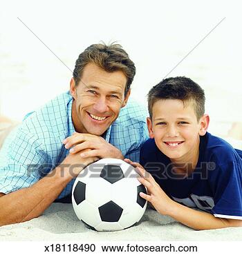 Stock Photography - portrait of father 
and son (10-11) 
with soccer ball. 
fotosearch - search 
stock photos, 
pictures, images, 
and photo clipart