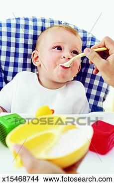 Stock Photo - close-up of father 
feeding baby boy 
(6-12 months). 
fotosearch - search 
stock photos, 
pictures, images, 
and photo clipart