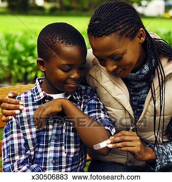 Stock Photo - close-up of mother 
putting plaster 
on son's hand 
(10-11). fotosearch 
- search stock 
photos, pictures, 
images, and photo 
clipart