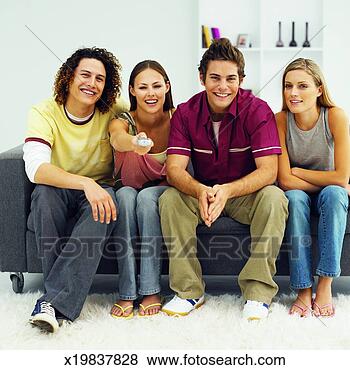 Stock Photo - front view of 
four young people 
watching television. 
fotosearch - search 
stock photos, 
pictures, images, 
and photo clipart
