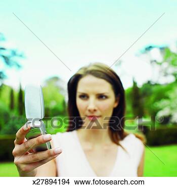 Stock Photo - woman using mobile 
phone. fotosearch 
- search stock 
photos, pictures, 
images, and photo 
clipart