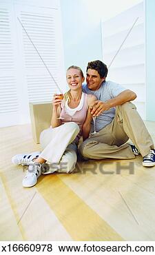 Stock Photo - couple celebrating 
after buying a 
house. fotosearch 
- search stock 
photos, pictures, 
images, and photo 
clipart