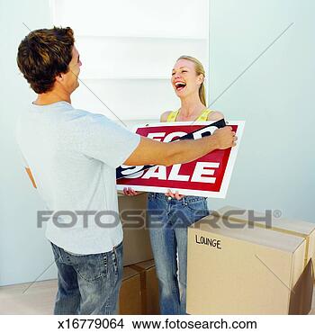 Stock Photo - delighted couple 
after buying a 
house. fotosearch 
- search stock 
photos, pictures, 
images, and photo 
clipart