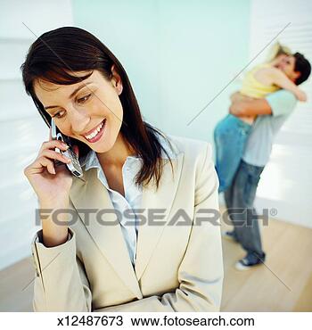Stock Photo - real estate agent 
talking on a mobile 
phone after selling 
a house to. fotosearch 
- search stock 
photos, pictures, 
images, and photo 
clipart