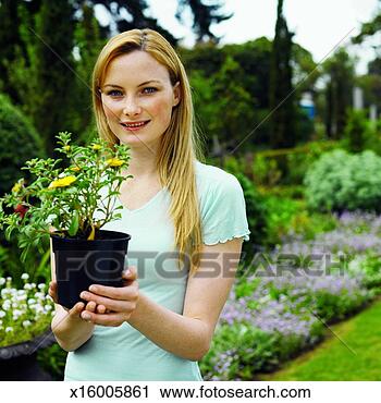 Stock Photography - woman holding 
a potted plant. 
fotosearch - search 
stock photos, 
pictures, images, 
and photo clipart
