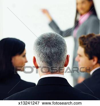 Picture - businesswoman 
giving presentation 
to three business 
executives. fotosearch 
- search stock 
photos, pictures, 
images, and photo 
clipart