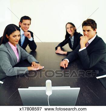 Picture - close-up of four 
business executives 
having video conference. 
fotosearch - search 
stock photos, 
pictures, images, 
and photo clipart