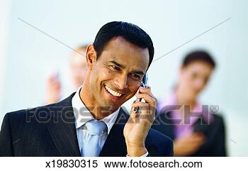 Stock Image - front view of 
three business 
executives talking 
on mobile phones. 
fotosearch - search 
stock photos, 
pictures, images, 
and photo clipart