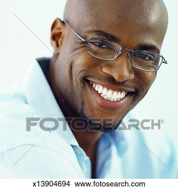 Stock Photo - close-up portrait 
of young man wearing 
glasses and smiling. 
fotosearch - search 
stock photos, 
pictures, images, 
and photo clipart