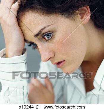 Stock Photography - close-up of a 
worried young 
woman with hand 
touching her head. 
fotosearch - search 
stock photos, 
pictures, images, 
and photo clipart
