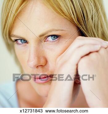 Stock Photo - front view portrait 
of young woman 
with hand touching 
her face. fotosearch 
- search stock 
photos, pictures, 
images, and photo 
clipart