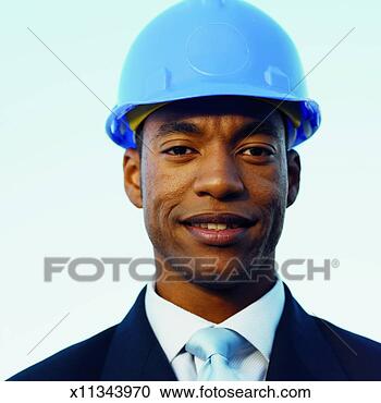 Stock Photography - front view portrait 
of businessman 
smiling and wearing 
hard hat. fotosearch 
- search stock 
photos, pictures, 
images, and photo 
clipart