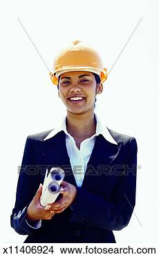 Stock Photo - front view portrait 
of businesswoman 
wearing hard hat 
and holding. fotosearch 
- search stock 
photos, pictures, 
images, and photo 
clipart