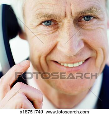 Stock Photograph - front view portrait 
of businessman 
talking on telephone. 
fotosearch - search 
stock photos, 
pictures, images, 
and photo clipart