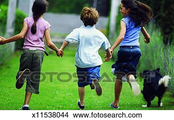 Stock Photo - boy (10-11) running 
with two girls 
(11-12). fotosearch 
- search stock 
photos, pictures, 
images, and photo 
clipart