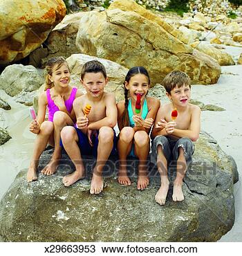 Stock Photo - front view portrait 
of four children 
sitting on rock 
(8-10). fotosearch 
- search stock 
photos, pictures, 
images, and photo 
clipart