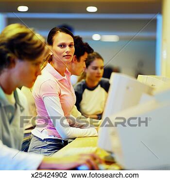 Stock Photo - four young people 
sitting in computer 
lab. fotosearch 
- search stock 
photos, pictures, 
images, and photo 
clipart