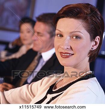 Stock Photograph - side profile of 
a business woman 
smiling at a business 
meeting. fotosearch 
- search stock 
photos, pictures, 
images, and photo 
clipart