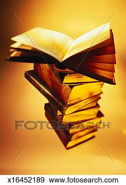 Stock Photograph - sepia toned close-up 
of an open book 
kept on a stack 
of books. fotosearch 
- search stock 
photos, pictures, 
images, and photo 
clipart