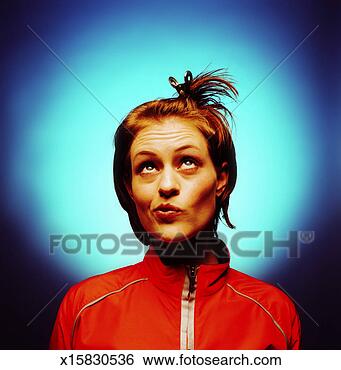 Stock Photo - portrait of a 
young woman wearing 
a clip with a 
confused expression. 
fotosearch - search 
stock photos, 
pictures, images, 
and photo clipart