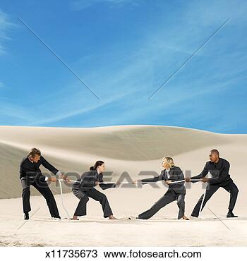 Stock Photo - a group of young 
business executives 
playing tug of 
war. fotosearch 
- search stock 
photos, pictures, 
images, and photo 
clipart