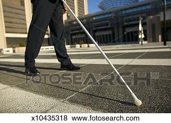 Stock Photo - low angle low 
section view of 
a blind man walking 
with the aid of 
a. fotosearch 
- search stock 
photos, pictures, 
images, and photo 
clipart